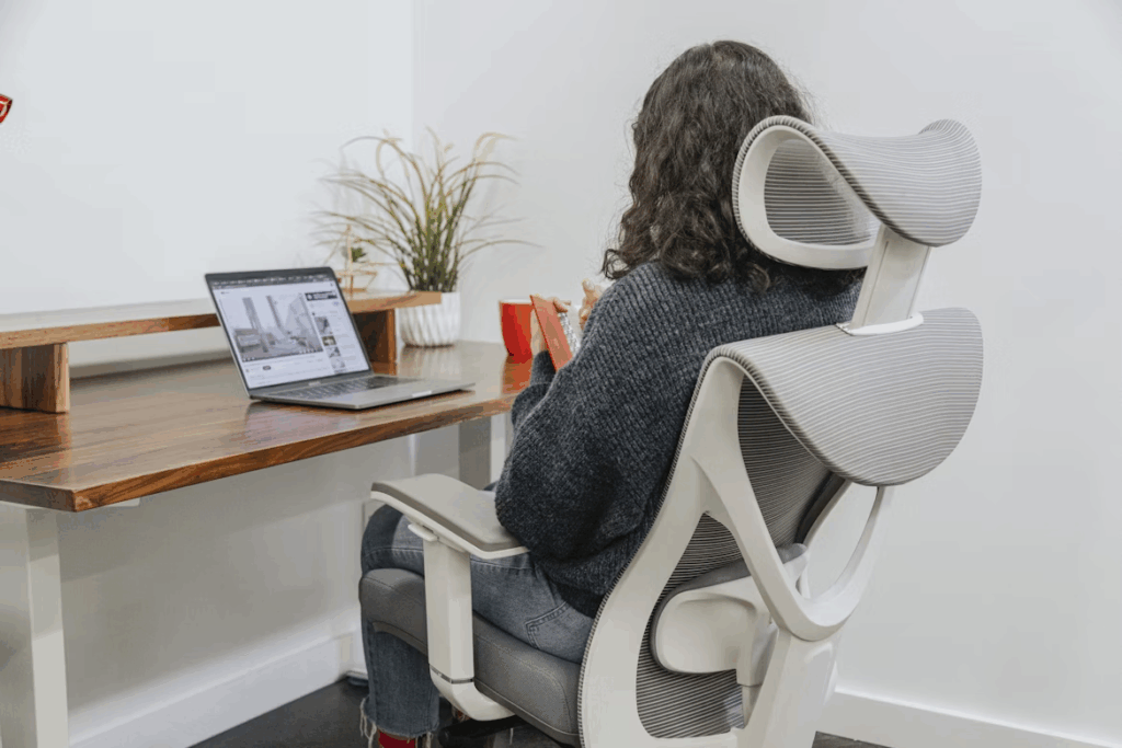 Home office ergonomics with lumbar-support chair and eye-level laptop stand.