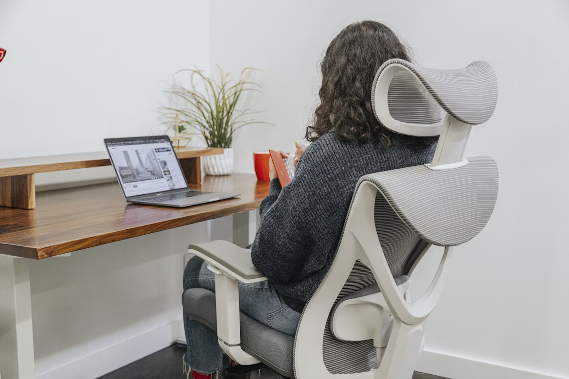 Home office ergonomics with lumbar-support chair and eye-level laptop stand.