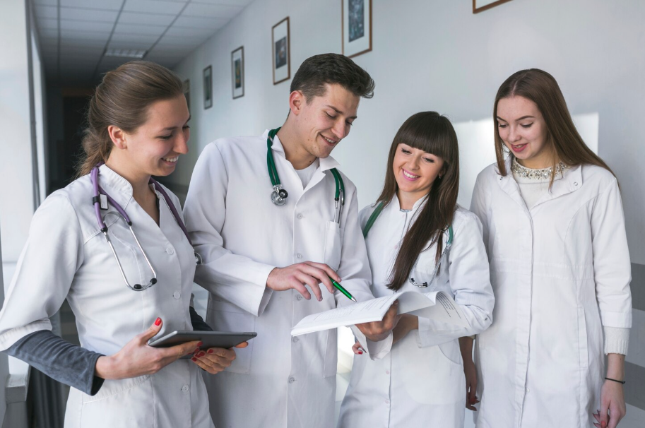 Diverse healthcare professionals in white coats reviewing patient notes