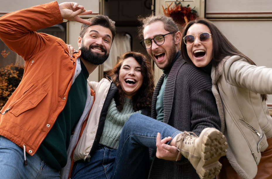 Four friends laughing with each, illustrating social health benefits like connection and happiness.