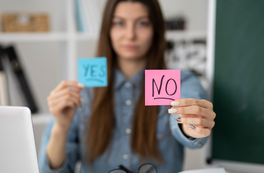 Woman holds “NO” and “YES” sticky notes, emphasizing boundary setting