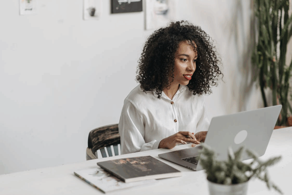 Woman working on a laptop, illustrating skill-building side hustles.
