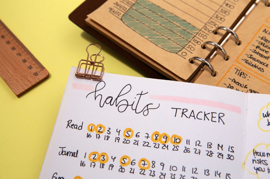 Handwritten habits tracker in a planner with circled dates, used to track daily routines